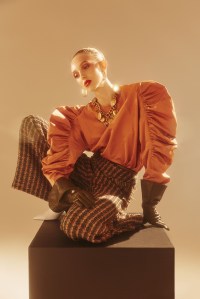 Dries Van Noten’s silk and polyester top; Anna Sui’s acrylic, polyester, wool, elastane and nylon trousers. Fendi earrings; Versace necklace; Marc Jacobs gloves; APC ring; Paul Andrew boots.