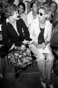 Loulou de la Falaise and Lauren Bacall seated in the front row during the Yves St. Laurent fall 1972 Couture collection.