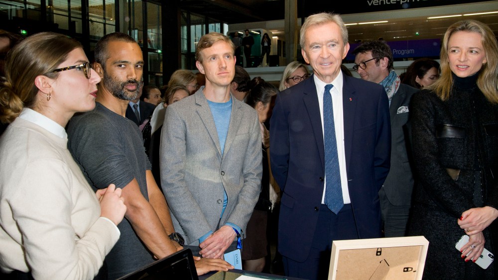 Bernard Arnault, Ian Rogers, and Delphine Arnault checking out an exhibit at Station F.