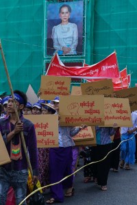 Workers with minimum wage slogans marching in downtown Yangon.