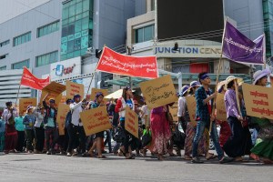 Workers with minimum wage slogans marching in downtown Yangon.