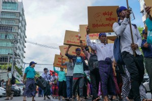 Workers with minimum wage slogans marching in downtown Yangon.