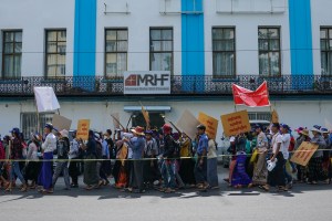 Workers with minimum wage slogans marching in downtown Yangon.