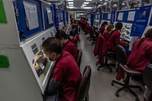 Employees polish jewelry.