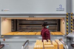 A female employee moves wax moldes into storage.
