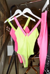 A neon yellow bodysuit with pink straps from the Heroine x Tracy Anderson collection.