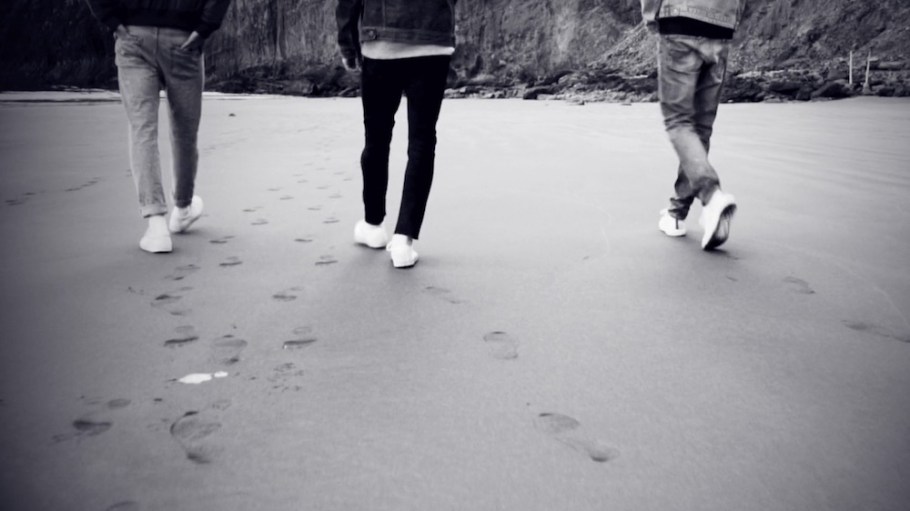 people wearing jeans on beach