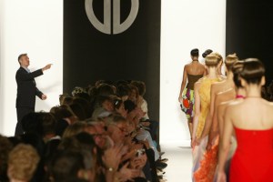 Designer Michael Vollbracht makes a brief appearance as models parade on the runway at the conclusion of the presentation of the Spring 2005 collection of Bill Blass.
