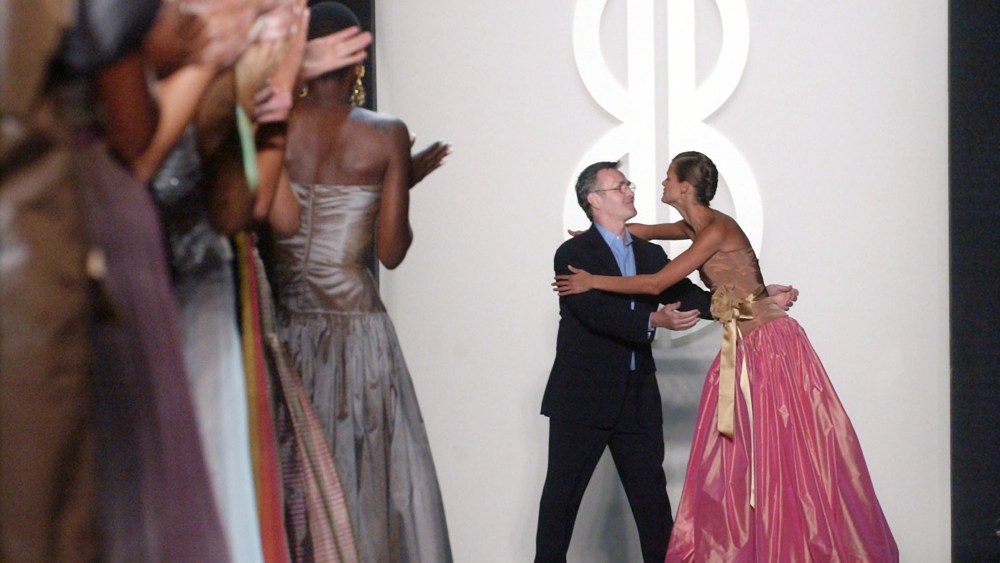 Michael Vollbracht, center, embraces a model after the Bill Blass spring 2004 collection, which featured his designs, during the Mercedes Benz Fashion Week in New YorkFASHION BLASS, NEW YORK, USA
