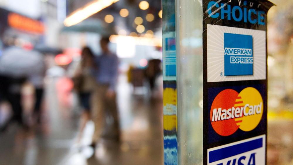 Signs for American Express, Master Card and Visa credit cards are shown on a New York store's doorCredit Cards Minimum Payments, New York, USA