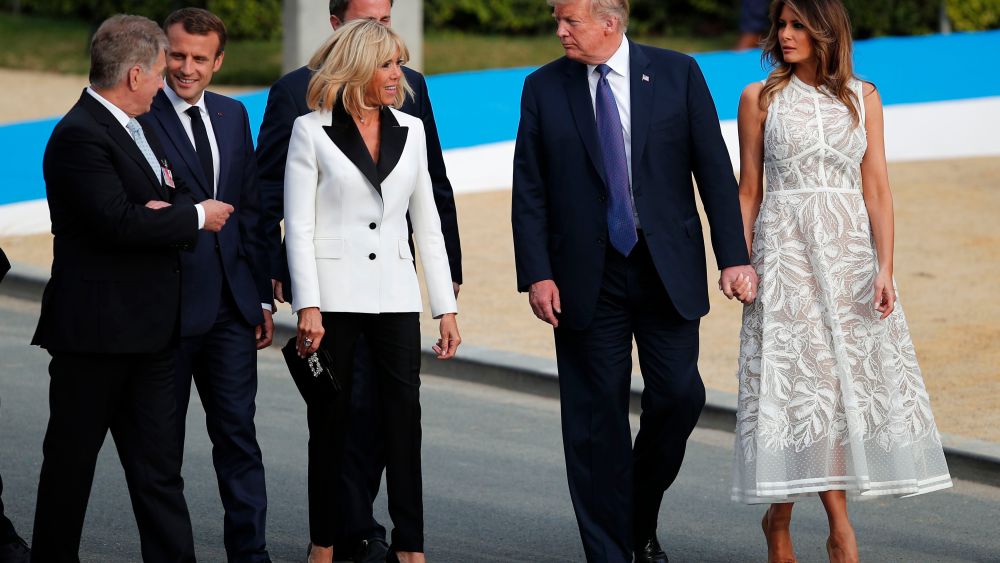 President Donald Trump with U.S. first lady Melania Trump walk with French President Emmanuel Macron and French first lady Brigitte Macron during a group photo of NATO heads of state and government at Park Cinquantenaire in Brussels on . NATO leaders gathered in Brussels Wednesday for a two-day summit to discuss Russia, Iraq and their mission in Afghanistan