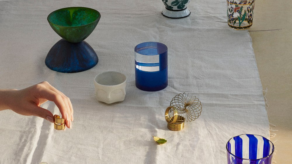 From top, clockwise: Gucci's coffee pot; Lobmeyr's floral motif tumbler at Moda Operandi; Laguna B's glass, available exclusively at Moda Operandi; Carl AbockÕs brass paperweight available at Matches.com; Jennifer FisherÕs 10-karat gold-plated ring; Dinosaur Designs' resin bowl, available at Moda Operandi; Jonathan Adler's votive candleholder, and Poltrona Frau Style and Design CentreÕs plexi case.