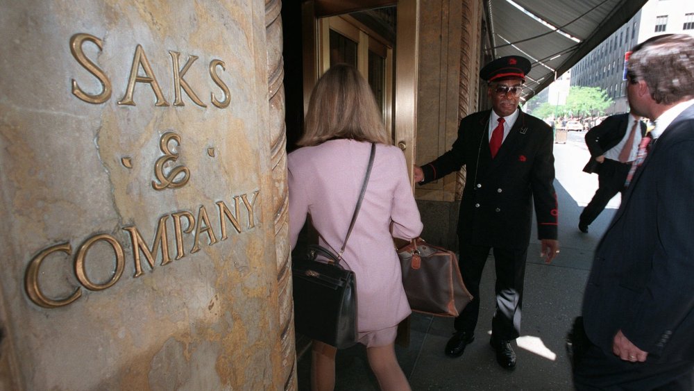 BOND Saks & Company doorman Haywood Bond, a 17-year employee, opens the 50th Street store entrance for customersSAKS FIFTH AVENUE, NEW YORK, USA
