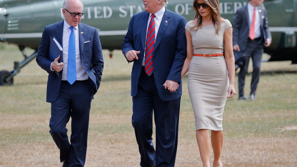 President Donald Trump, center, and first lady Melania Trump, right, walk with Woody Johnson, left, United States Ambassador to the United Kingdom