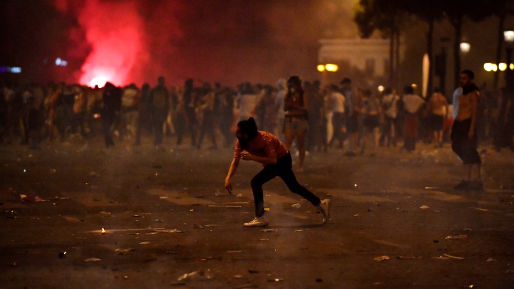 French riot police disperse people on Champs-Elysees avenue after French supporters celebrated the victory of France at the FIFA World Cup 2018 final match against Croatia in Paris, France, 15 July 2018.French feature FIFA World Cup 2018, Paris, France - 15 Jul 2018