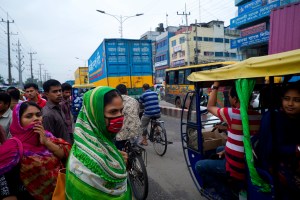 More than 500,000 garment workers are employed by Chittagong's garment factories, which produce roughly 15 percent of Bangladesh's garment exports overseas. Garment workers look before crossing a hectic road as they leave work for the day.
