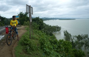 A man looks across the Naf river. More than 700,000 Rohingya refugees have crossed the Naf River from Myanmar into Bangladesh to flee persecution from the Myanmar military.