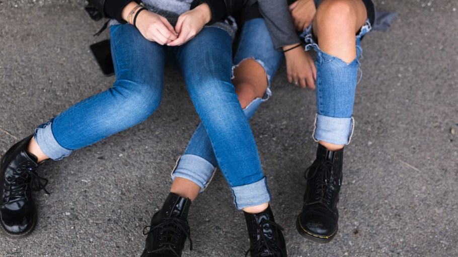 Jeans and boots of two teenagers