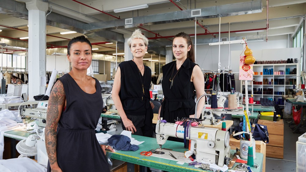 Laura Marin, a recent graduate of Course of Trade, a training program in sewing for the apparel sector hosted in the headquarters of designer Malia Mills, center, and Libby Mattern, the Production Director for Swimwear and Ready to Wear of Malia Mills and founder of Course of Trade.