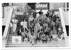 Rudi Gernreich seated dead center in a black zip-front suit on the steps of LACMA with leading artists of his time.