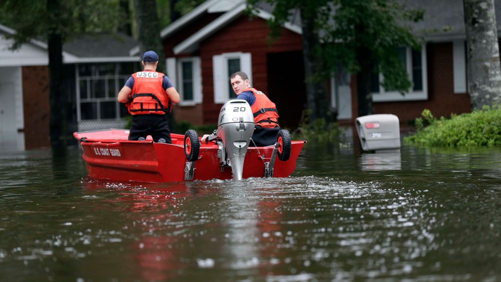Members of the U.S. Coast Guard check on a neighborhood in Lumberton, N.C., following flooding from Hurricane FlorenceTropical Weather North Carolina, Lumberton, USA - 16 Sep 2018