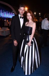 Travis Mills, Madelaine Petsch. Travis Mills, left, and Madelaine Petsch attend the Governors Ball for the 70th Primetime Emmy Awards, at the Microsoft Theater in Los Angeles70th Primetime Emmy Awards - Governors Ball, Los Angeles, USA - 17 Sep 2018