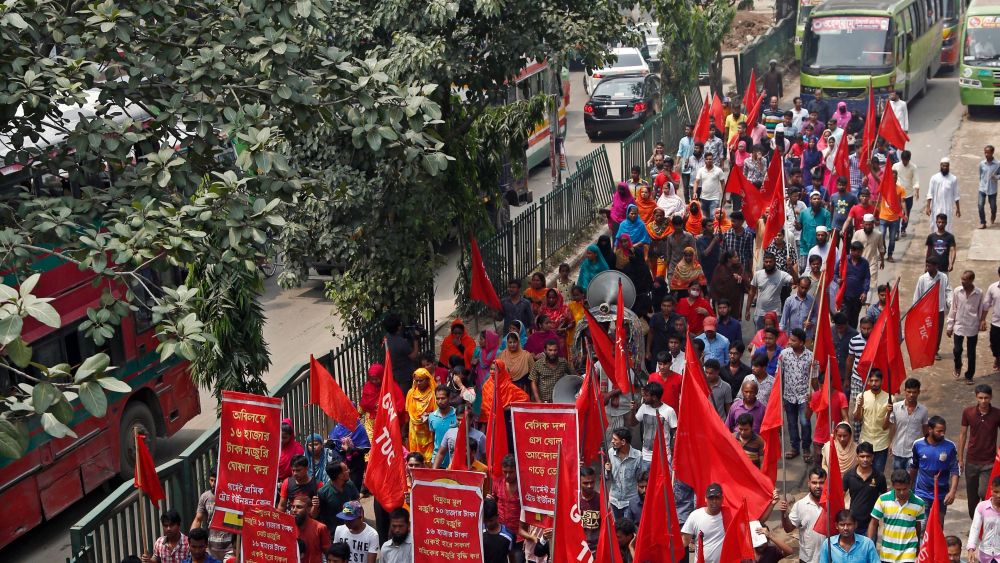 Bangladeshi garment workers shout slogans during a protest rally blocking a road in Dhaka, Bangladesh, 14 September 2018. According to media reports, workers from ready-made garment factories rejected the government's decision to raise their minimum monthly wage to 8,000 as they demanded instead a minimum monthly wage up to 16,000, for an estimate of 4.4 million garment workers.Garment workers stage demonstration over minimum wage in Bangladesh, Dhaka - 14 Sep 2018