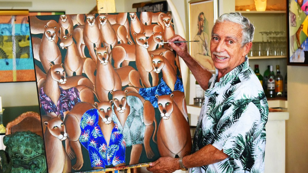 Artist Gustavo Novoa with his work inspired by the Cubavera.