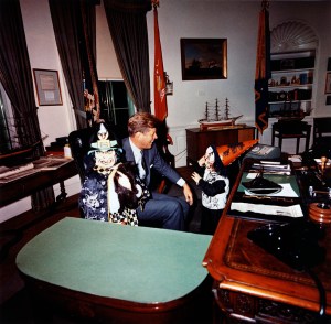 Caroline Kennedy and John F. Kennedy, Jr. visiting President John F. Kennedy in the Oval Office on Halloween in their costumes.