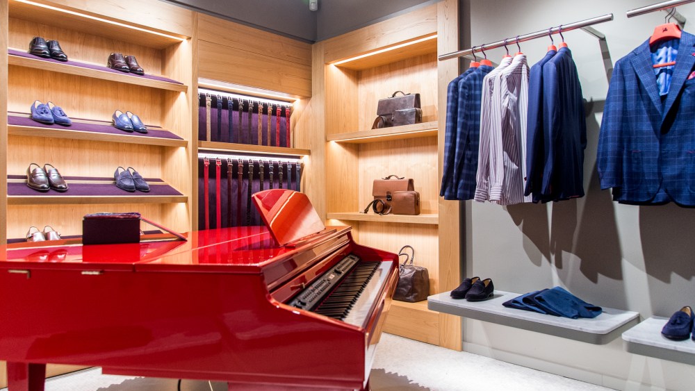 A red lacquered piano is a signature design feature in Isaia stores.