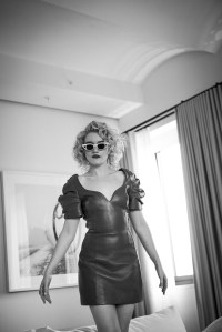 Julia Garner in Area’s lambskin leather dress. Adam Selman x Le Specs sunglasses.