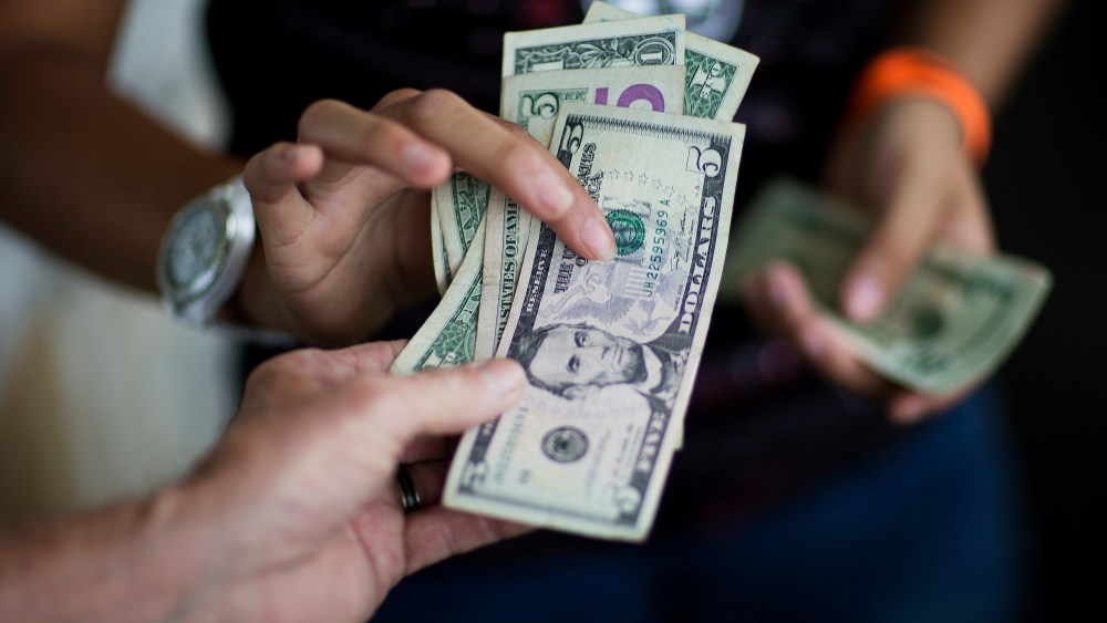 A customer, bottom, pays for goods while shopping at the Atlanta Farmers Market in Atlanta. On, the Commerce Department issues its May report on consumer spending, which accounts for roughly 70 percent of U.S. economic activityConsumer Spending, Atlanta, USA
