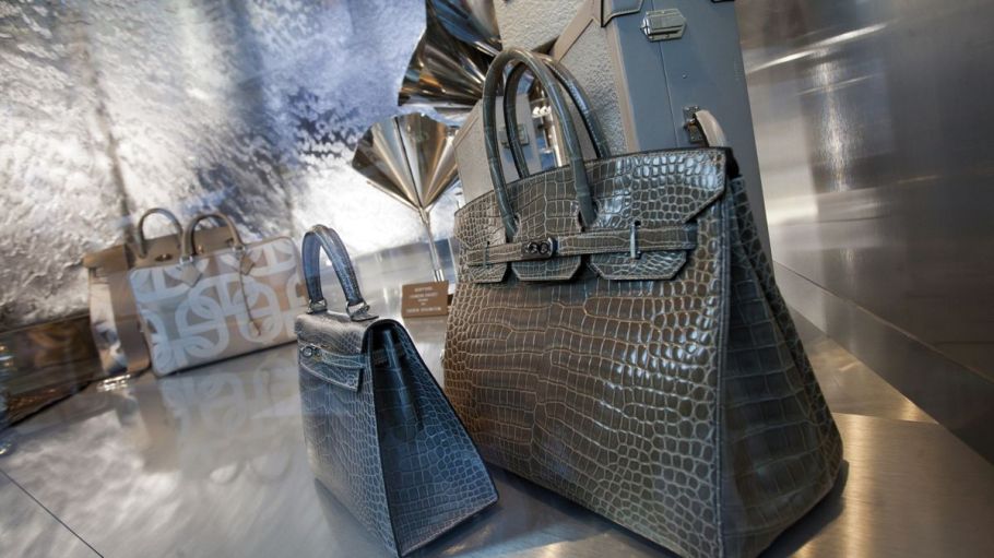 Hermes bags are seen on display in a store window.