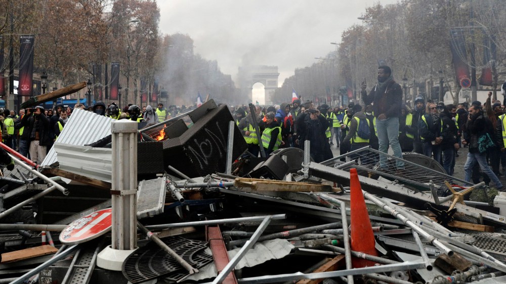 Demonstrators, called the yellow jackets, set up a makeshift barricade on the famed Champs Elysees avenue, during a protest against the rising of the fuel taxes, in Paris, France, . French police fired tear gas and water cannons to disperse demonstrators in Paris Saturday, as thousands gathered in the capital and staged road blockades across the nation to vent anger against rising fuel taxes and Emmanuel Macron's presidencyGas Price Protests, Paris, France - 24 Nov 2018