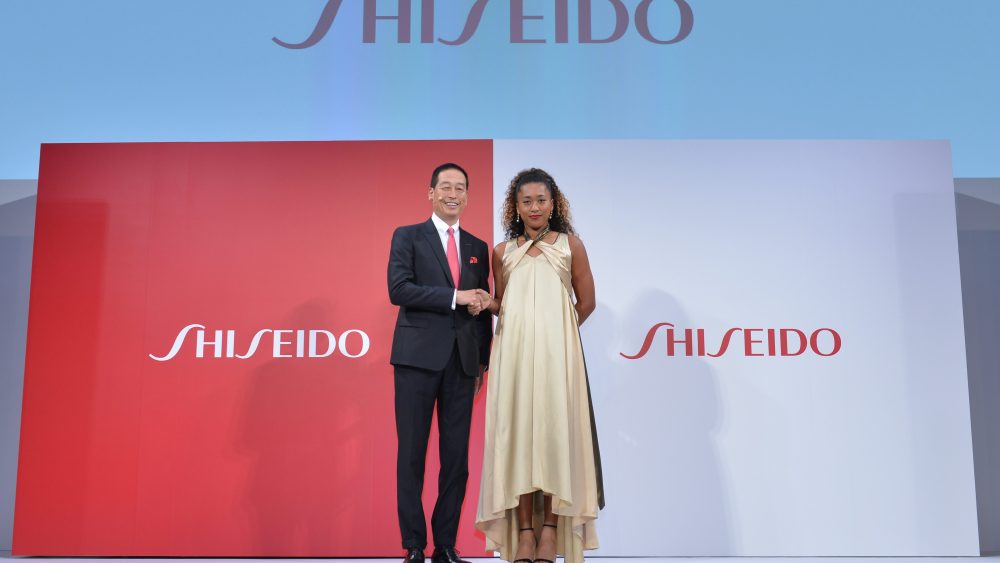 Shiseido's Masahiko Uotani stands with Naomi Osaka at the press conference announcing her ambassadorship for the beauty company.