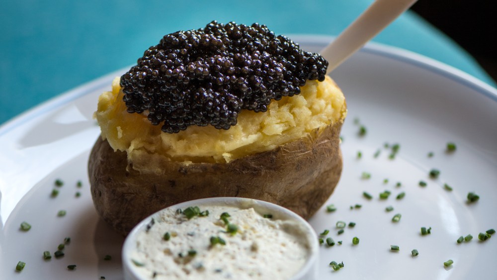 Caviar Kaspia's signature dish, a baked potato topped with caviar.
