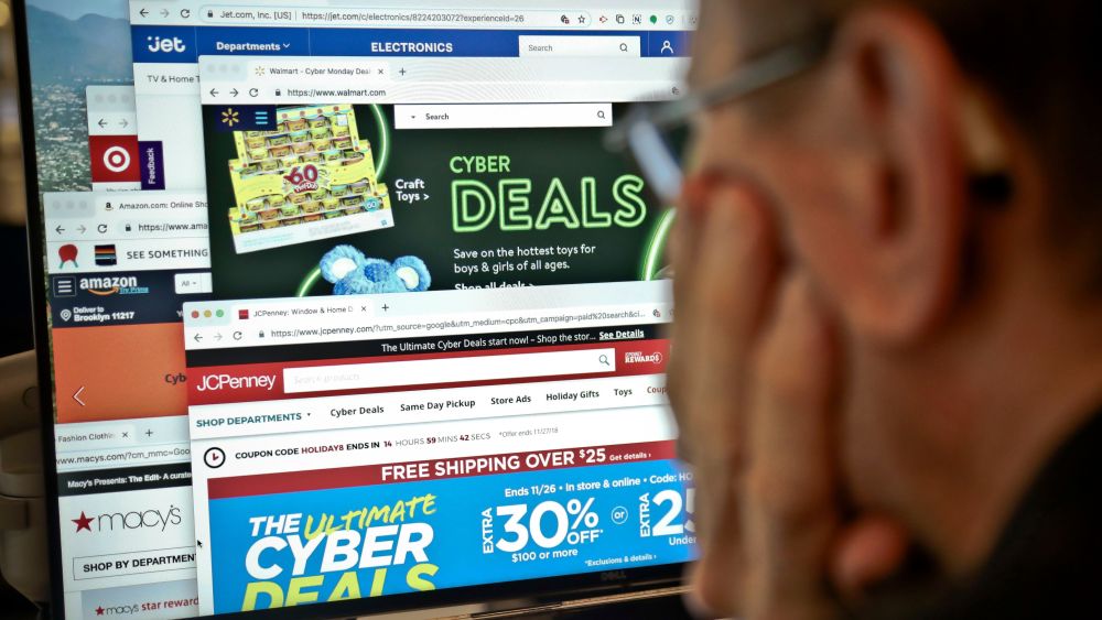 A journalist looks at a computer screen with webpages arranged to show Cyber Monday deals by various online retailers, in New York. The physical rush of Black Friday and the armchair browsing of Cyber Monday are increasingly blending into one big holiday shopping event as more customers buy items online and pick them up at brick-and-mortar storesHoliday Shopping, New York, USA - 26 Nov 2018