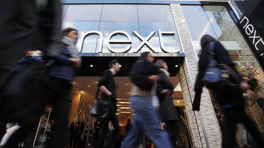 Pedestrians pass the Next flagship store on Oxford Street, in London, U.K.