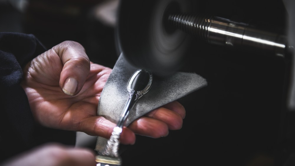 A Buccellati silversmith working at the dedicated hub.
