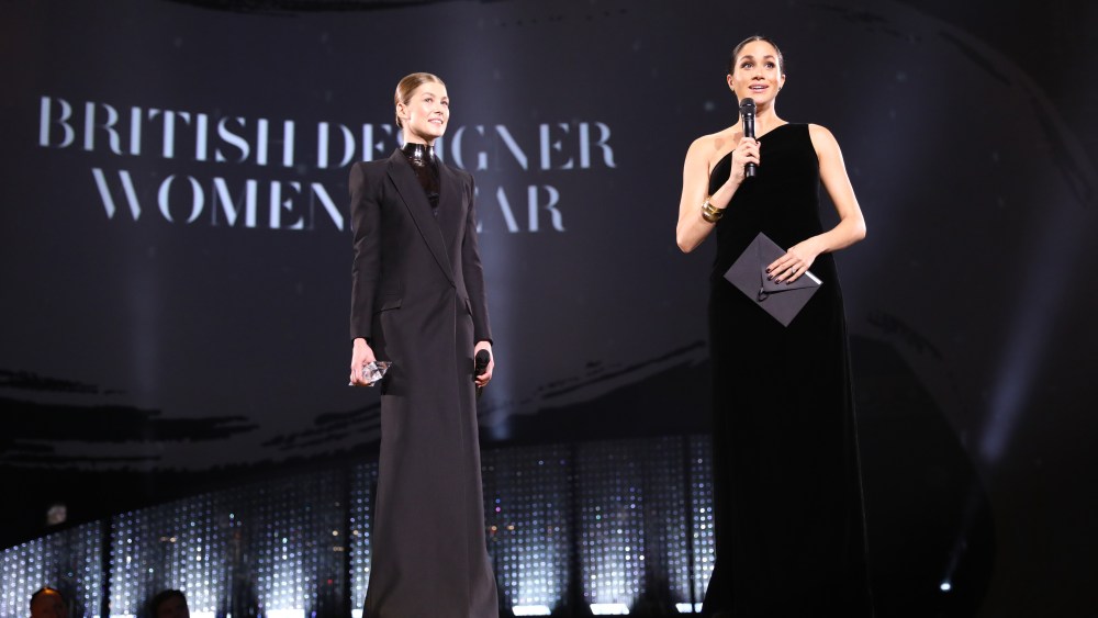 LONDON, ENGLAND - DECEMBER 10:  Meghan, Duchess of Sussex and Rosamund Pike on stage to present the British Designer of the Year Womenswear Award during The Fashion Awards 2018 In Partnership With Swarovski at Royal Albert Hall on December 10, 2018 in London, England.  (Photo by Tristan Fewings/BFC/Getty Images)