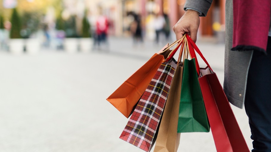 Man holding shopping bags with presents on the street