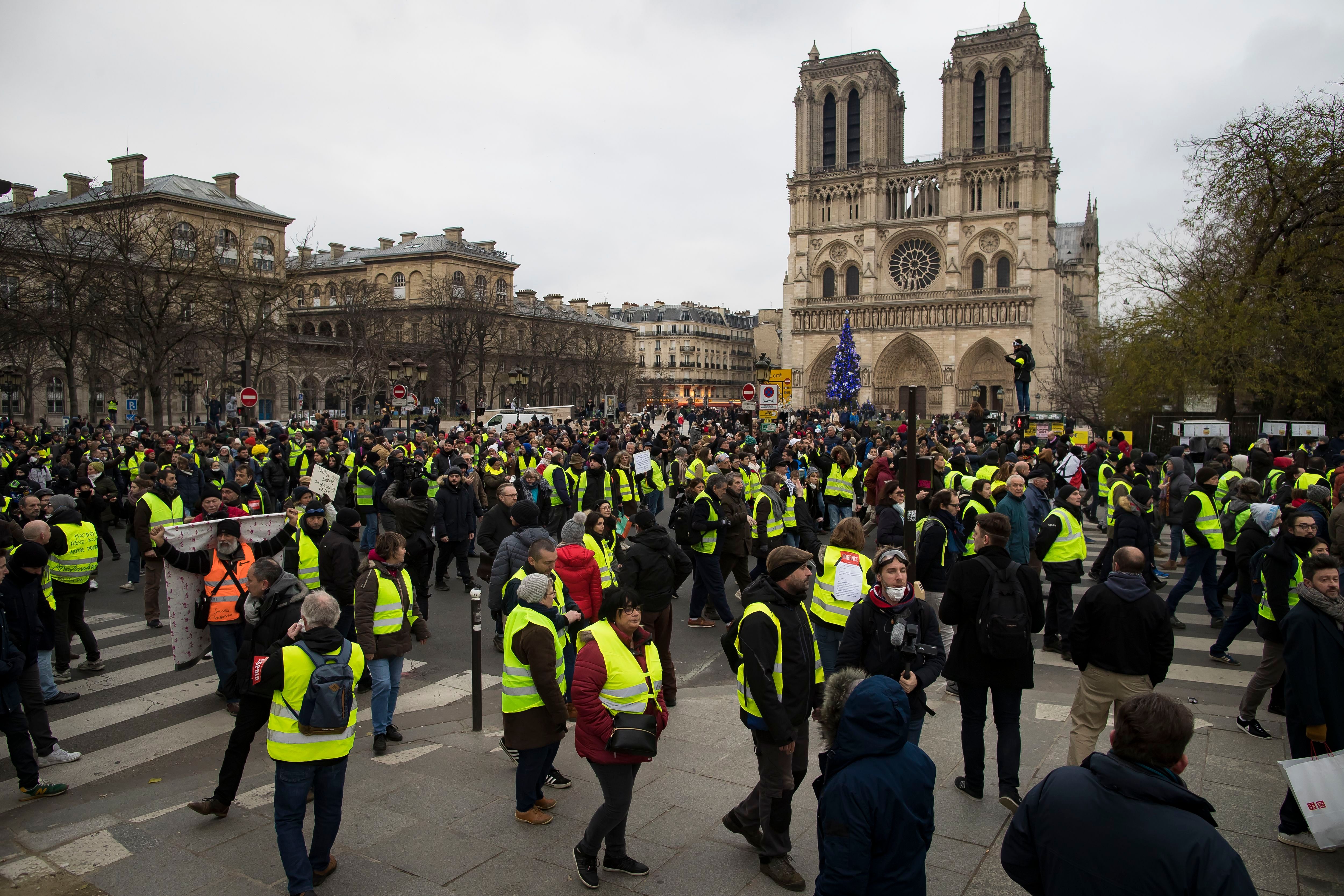Protesters walk alongside the Seine river during a 'Yellow Vests' protest in Paris, France, 05 January 2019. The so-called 'gilets jaunes' (yellow vests) is a grassroots protest movement with supporters from a wide span of the political spectrum, that originally started with protest across the nation in late 2018 against high fuel prices. The movement in the meantime also protests the French government's tax reforms, the increasing costs of living and some even call for the resignation of French President Emmanuel Macron.Yellow vests protest in Paris, France - 05 Jan 2019