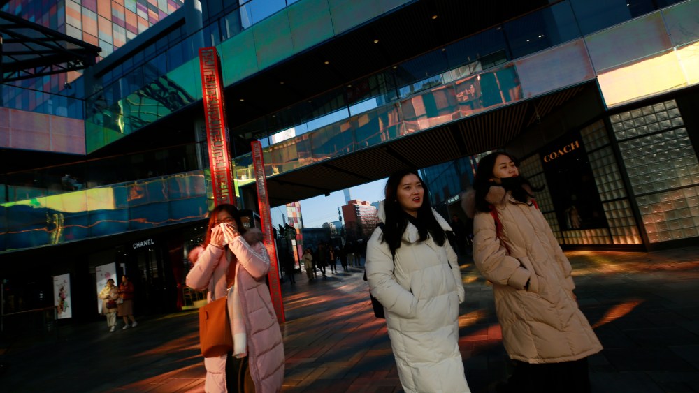 People walk through the Sanlitun Taikooli mall in Beijing.