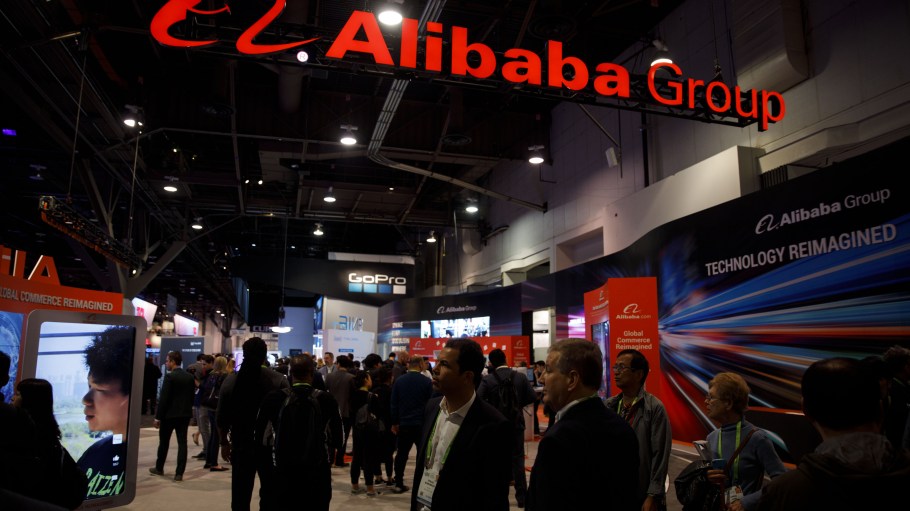 Attendees walk past the Alibaba Group Holding Ltd. booth at the 2019 Consumer Electronics Show (CES) in Las Vegas,