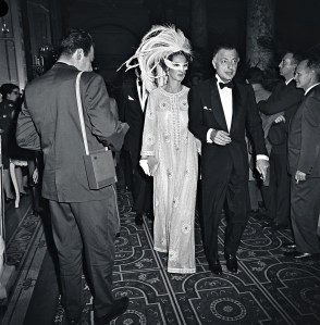 Marella (in a swan mask) and Gianni Agnelli arriving at Truman Capote's Black and White Ball in the Grand Ballroom at the Plaza Hotel in New York City