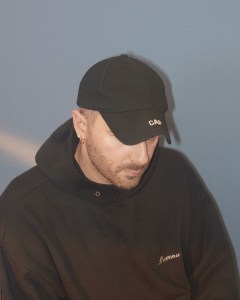 Designer Demna Gvasalia in his signature black baseball cap and oversized hoodie.