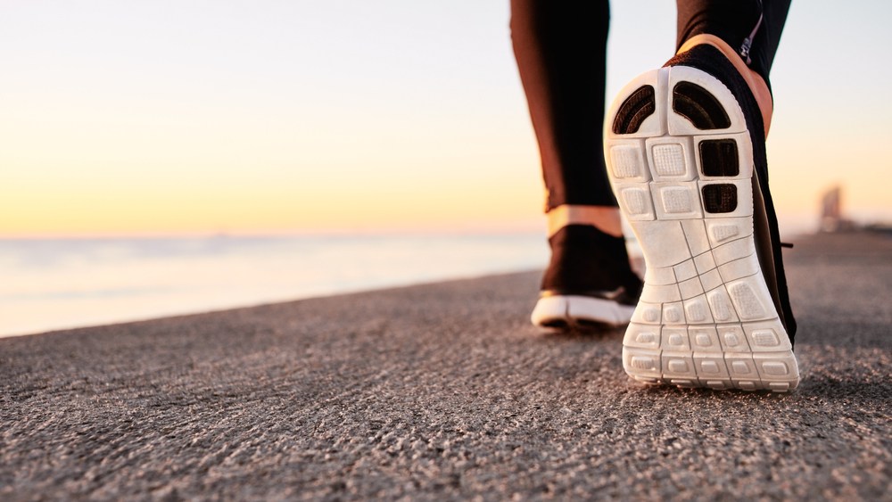 Image of a sneaker on the beach at sunset