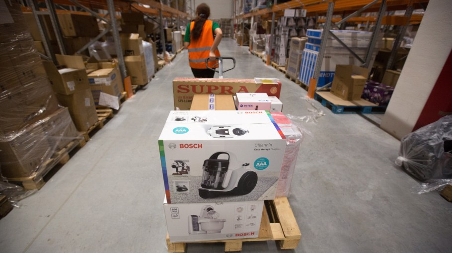 A worker moves electronic goods across the warehouse in the e-commerce distribution center operated by Alibaba Group Holding Ltd. in Domodedovo, Russia
