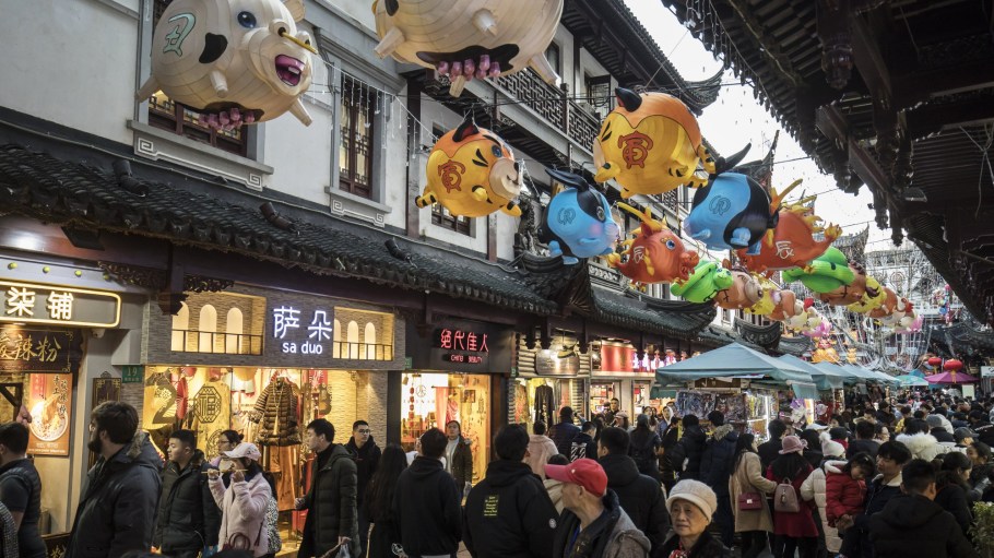 Pedestrians walk past stores as Chinese zodiac-themed paper lanterns are displayed at the Yuyuan Garden ahead of the Lunar New Year in Shanghai, China