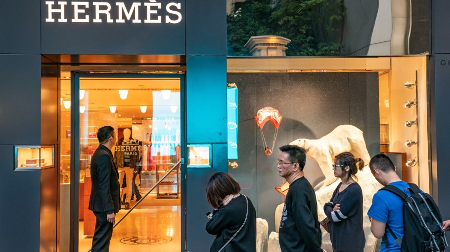 Shoppers wait in line outside a Hermes International SCA store on Canton Road in the Tsim Sha Tsui district of Hong Kong, China.